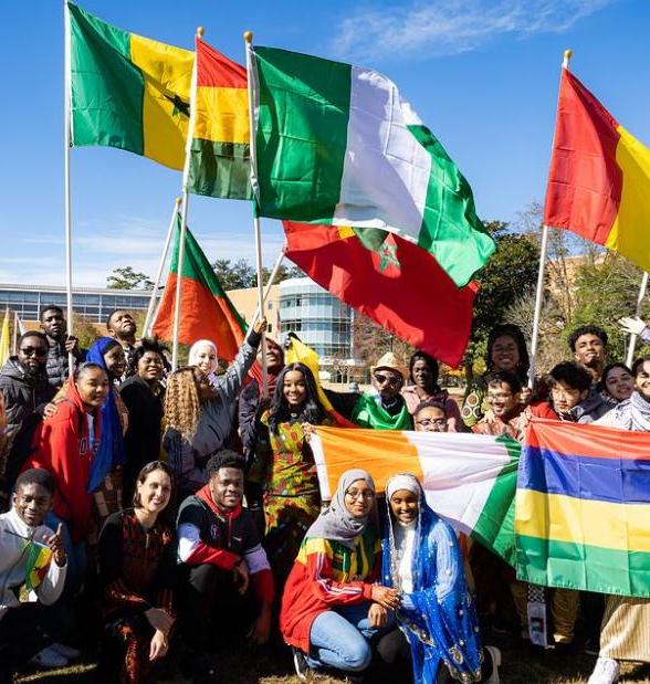 A picture of a group of international students with their flags